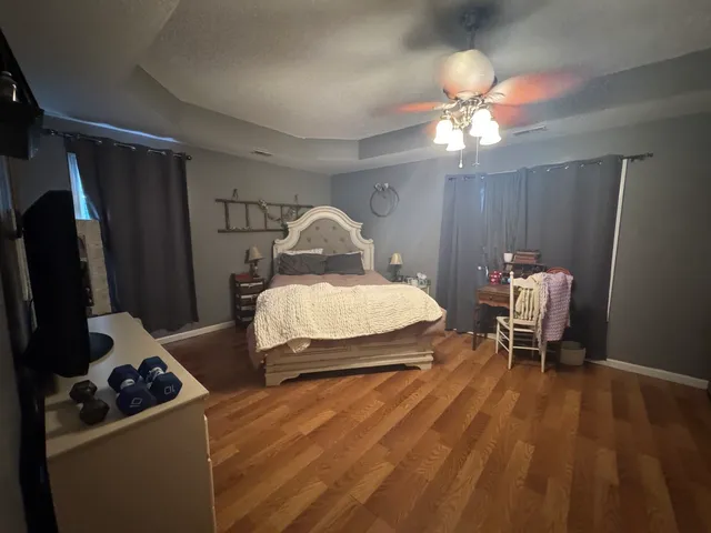 a bedroom with a bed and a chandelier