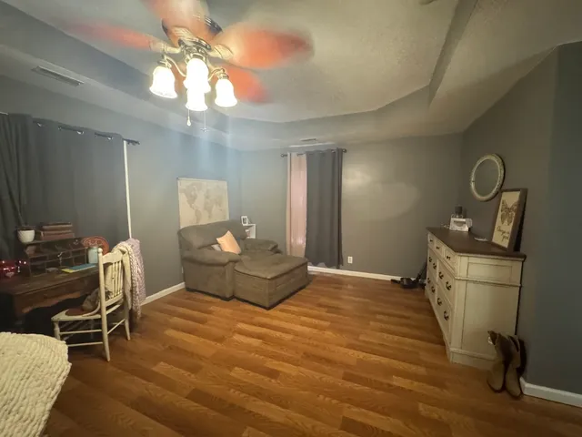 a bedroom with furniture and a chandelier
