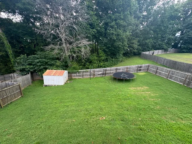 a backyard of a house with a yard and outdoor seating