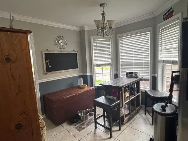 a living room with furniture a flat screen tv and a window
