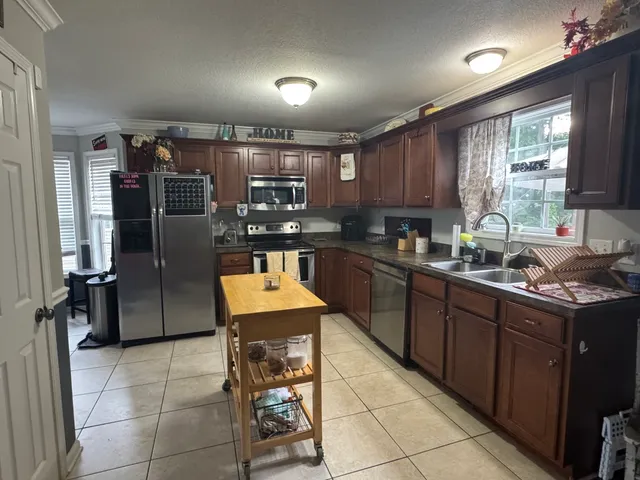 a kitchen with stainless steel appliances granite countertop a sink counter space cabinets and a counter top space