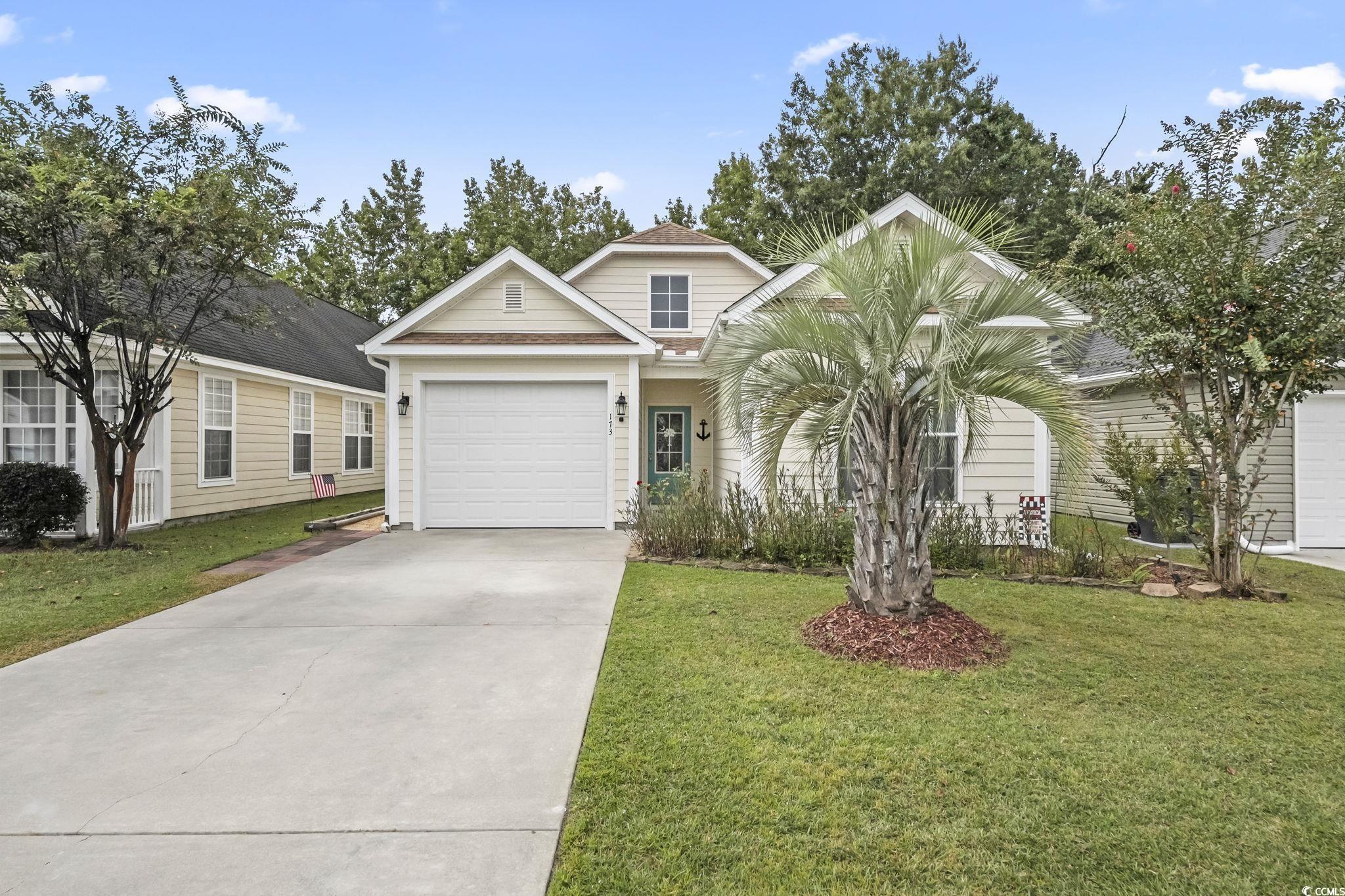173 Foxpath Loop Myrtle Beach, SC 29588 - Photo 1 of 31 View of front facade with a front yard, concrete driveway, and a garage