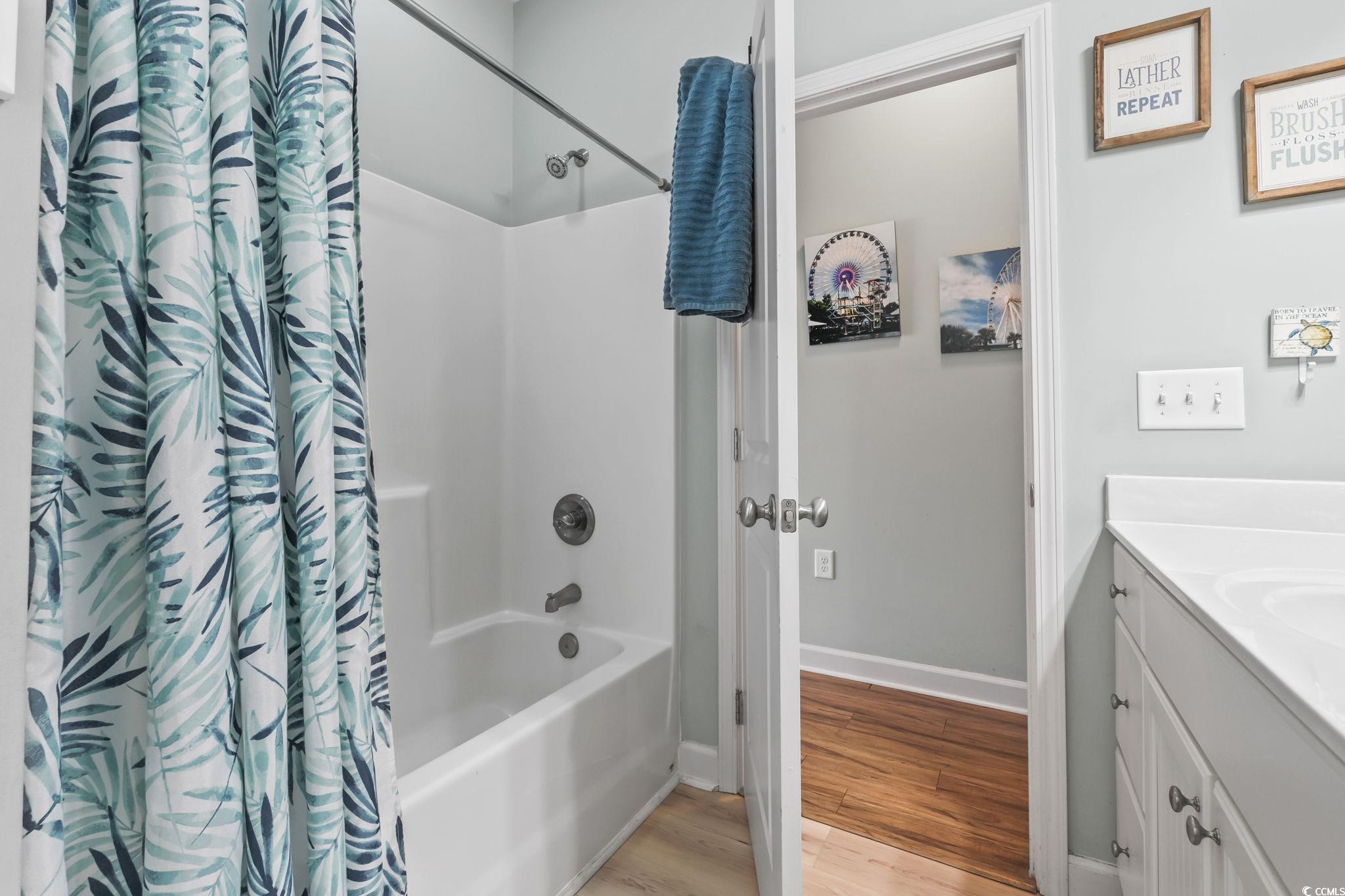 173 Foxpath Loop Myrtle Beach, SC 29588 - Photo 21 of 31 Bathroom with shower / bath combo with shower curtain, vanity, and light wood-type flooring
