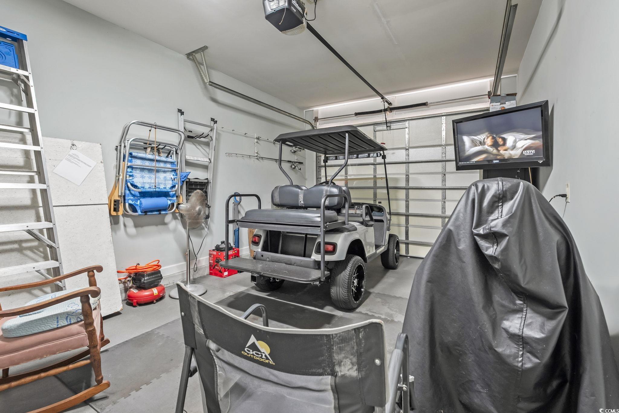 173 Foxpath Loop Myrtle Beach, SC 29588 - Photo 24 of 31 Garage featuring a garage door opener