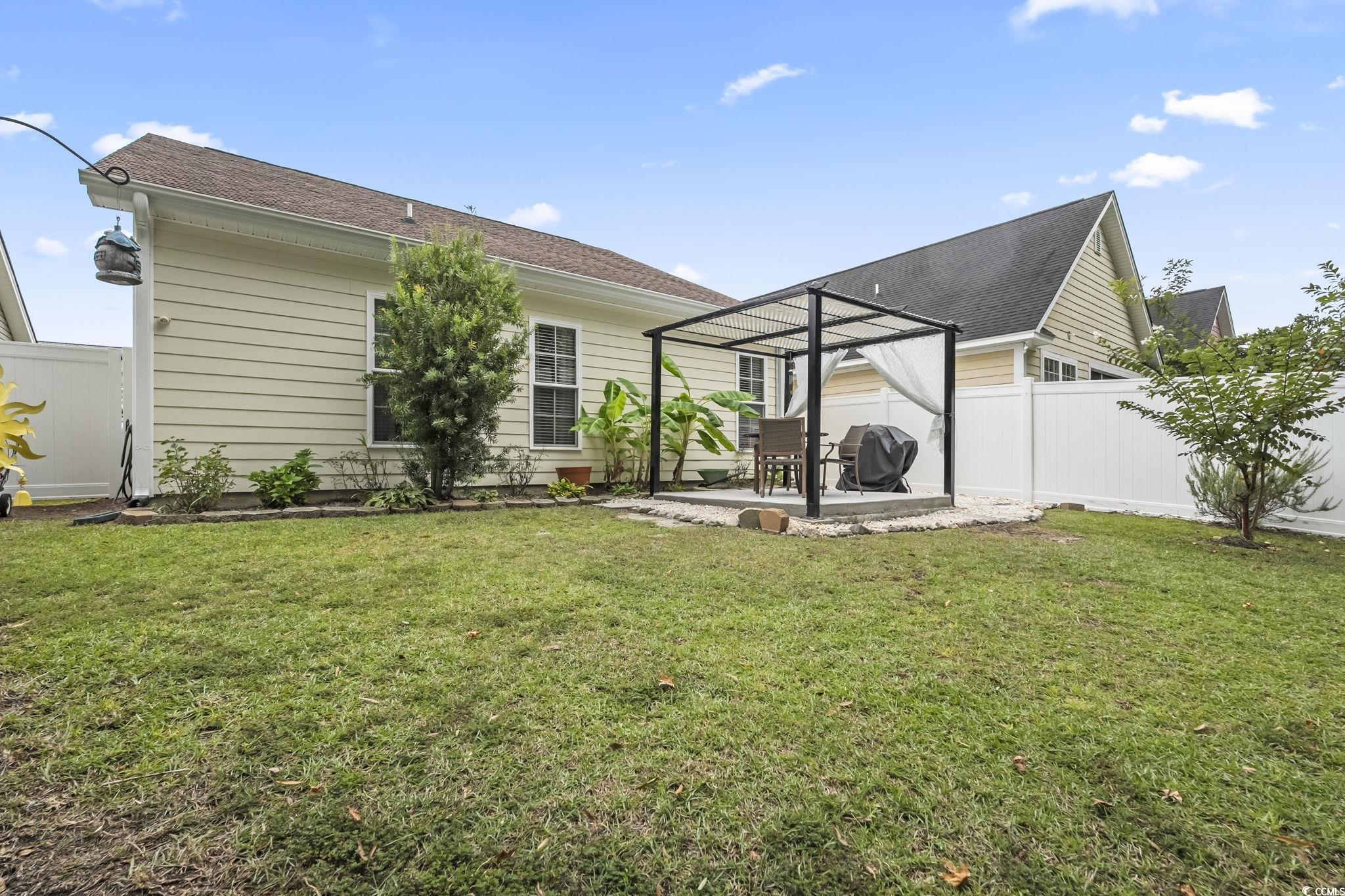 173 Foxpath Loop Myrtle Beach, SC 29588 - Photo 26 of 31 Back of property with a fenced backyard, a patio area, and a shingled roof