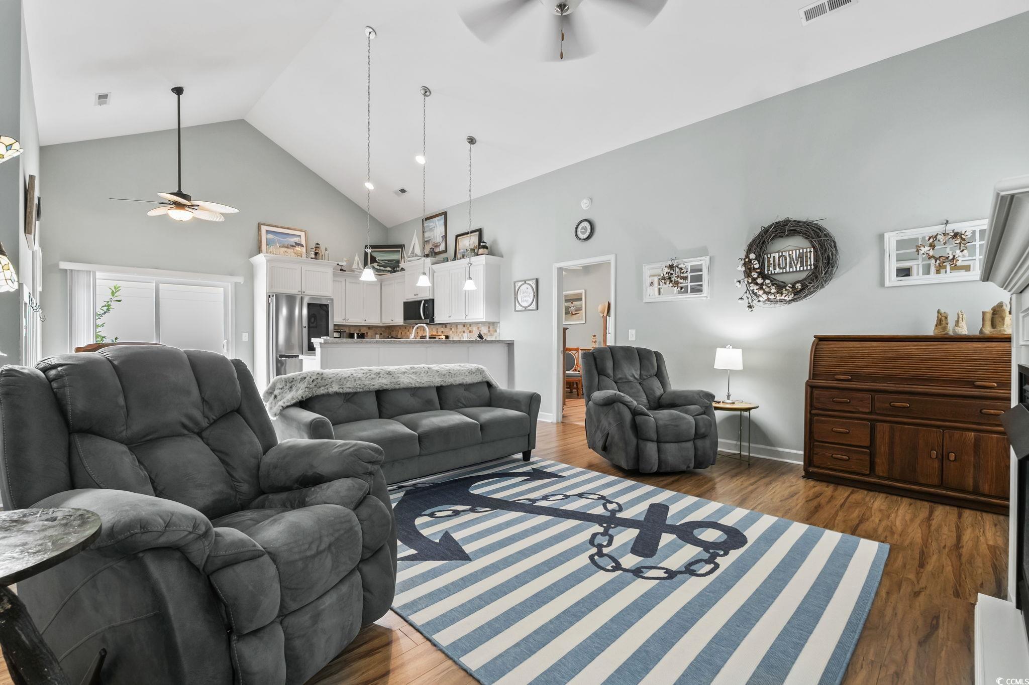 173 Foxpath Loop Myrtle Beach, SC 29588 - Photo 4 of 31 Living room featuring ceiling fan, high vaulted ceiling, and dark wood-type flooring