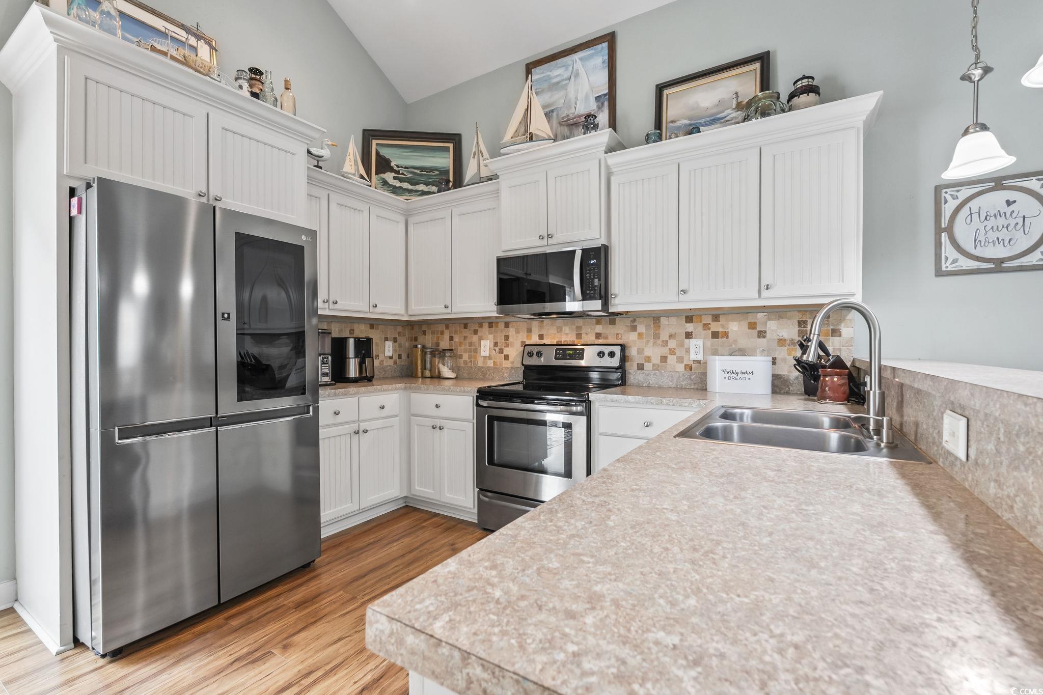 173 Foxpath Loop Myrtle Beach, SC 29588 - Photo 7 of 31 Kitchen with light countertops, appliances with stainless steel finishes, white cabinets, pendant lighting, and tasteful backsplash