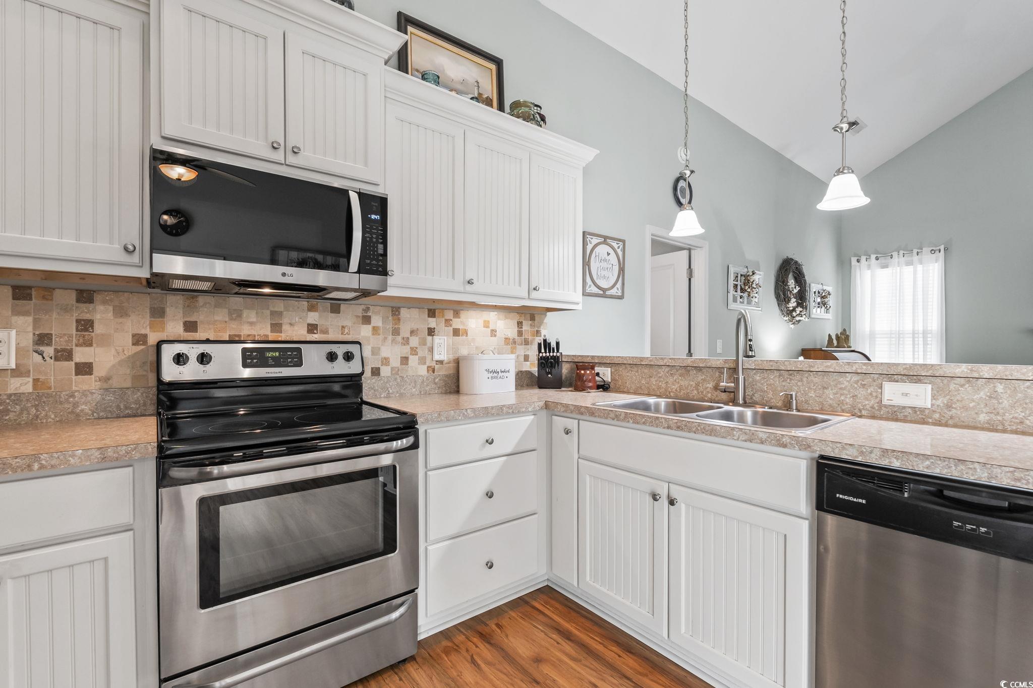 173 Foxpath Loop Myrtle Beach, SC 29588 - Photo 8 of 31 Kitchen featuring stainless steel appliances, white cabinetry, pendant lighting, decorative backsplash, and light countertops