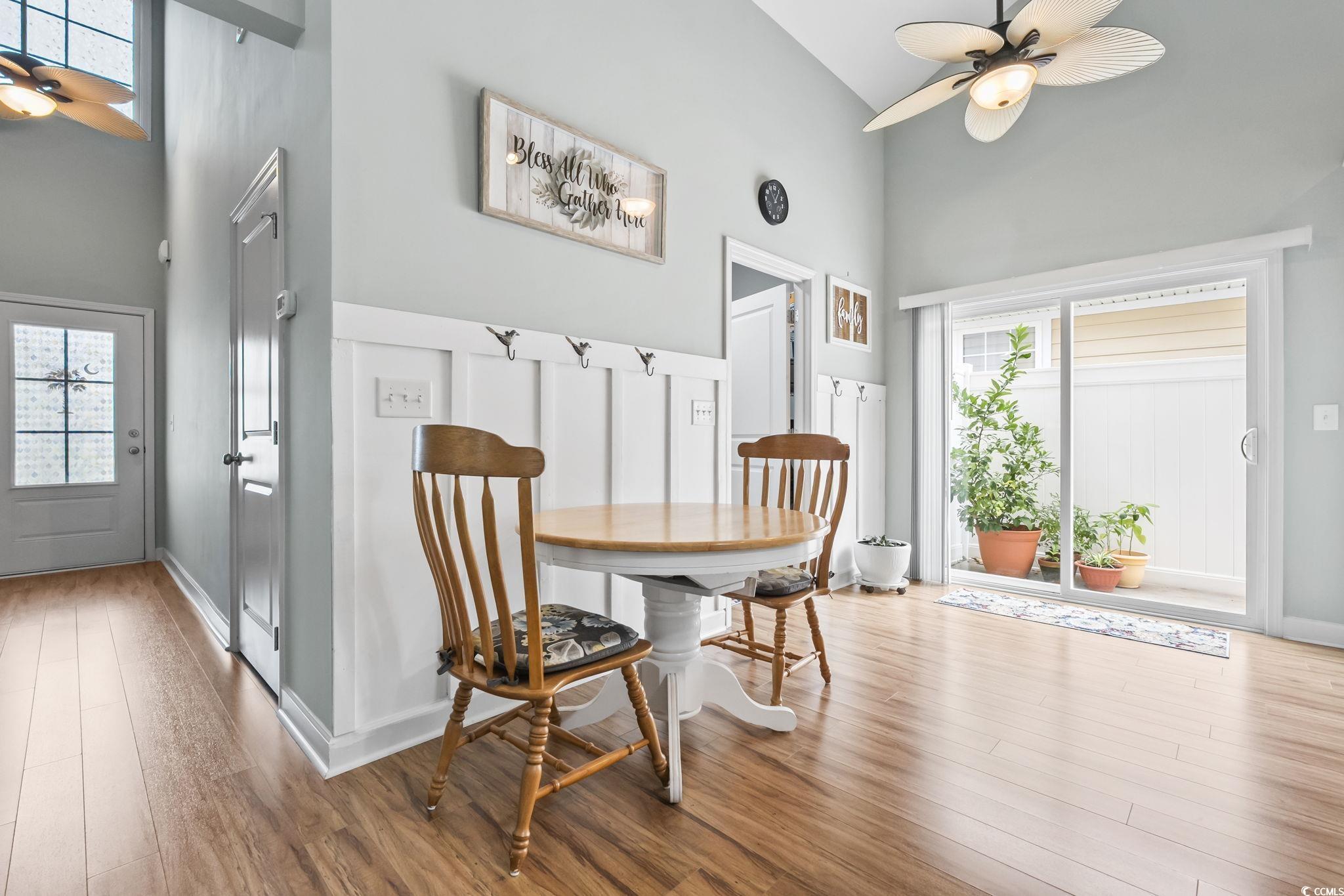 173 Foxpath Loop Myrtle Beach, SC 29588 - Photo 9 of 31 Dining area with a ceiling fan, a towering ceiling, and wood finished floors