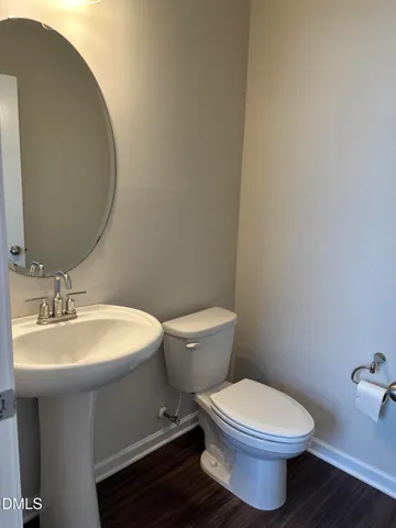 a white toilet sitting next to a bathroom sink