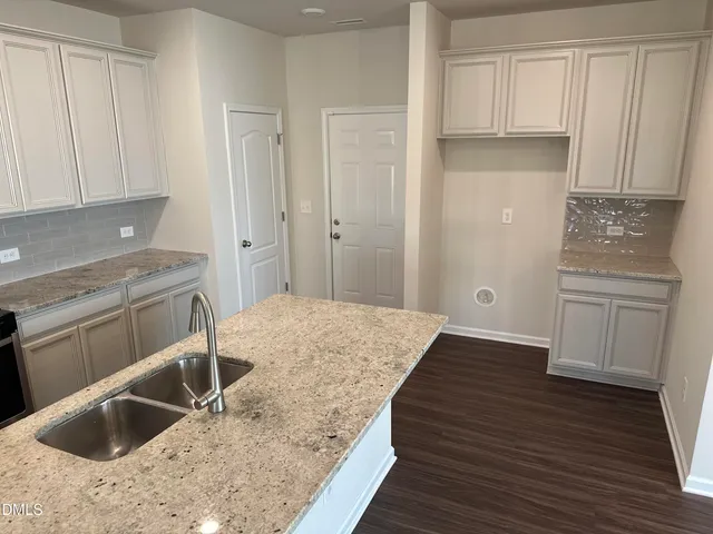 a kitchen with a sink and cabinets