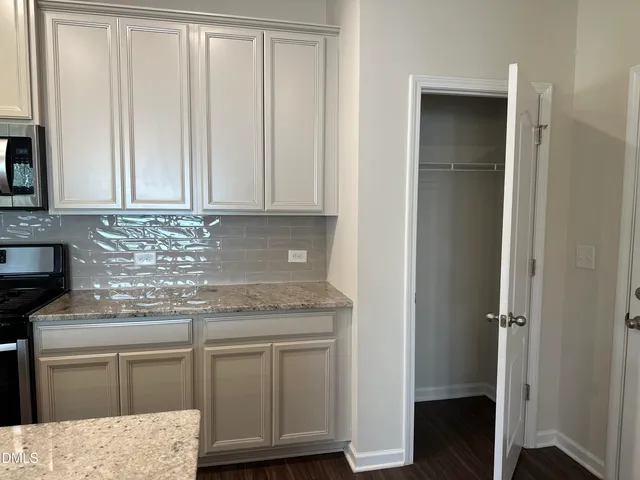 a kitchen with cabinets appliances and a counter space