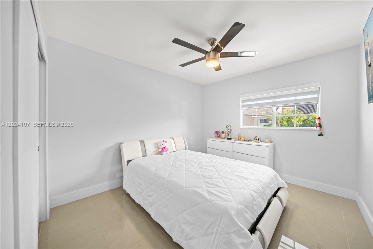 15341 Southwest 36th Street Miami, FL 33185 - Photo 37 of 56 a bedroom with a bed and a window