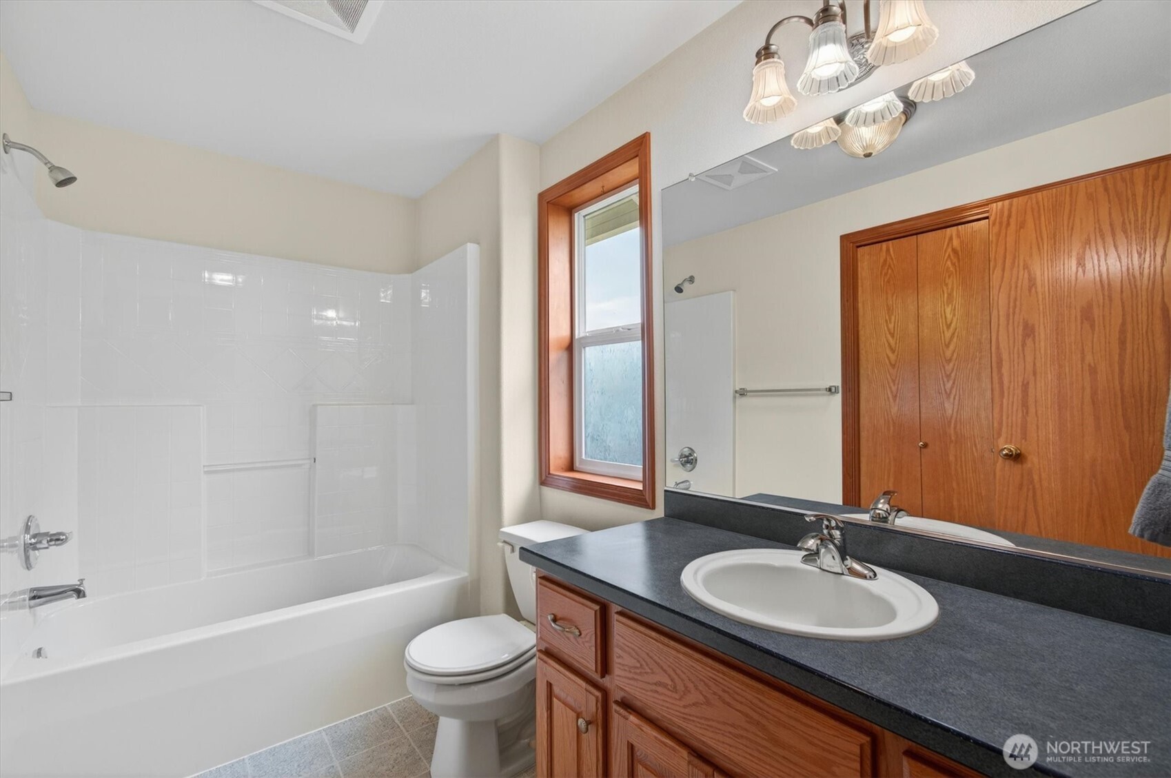 218 West Sunny Sands Road Cathlamet, WA 98612 - Photo 19 of 40 a bathroom with a granite countertop sink a toilet a mirror and shower