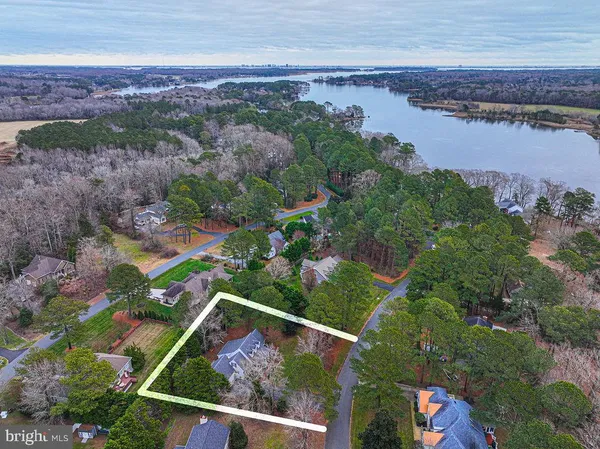a living room with furniture wooden floor and dining table