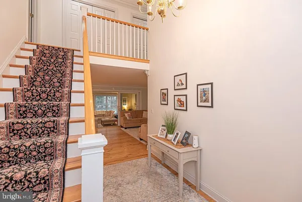 a dining room with furniture a chandelier and wooden floor