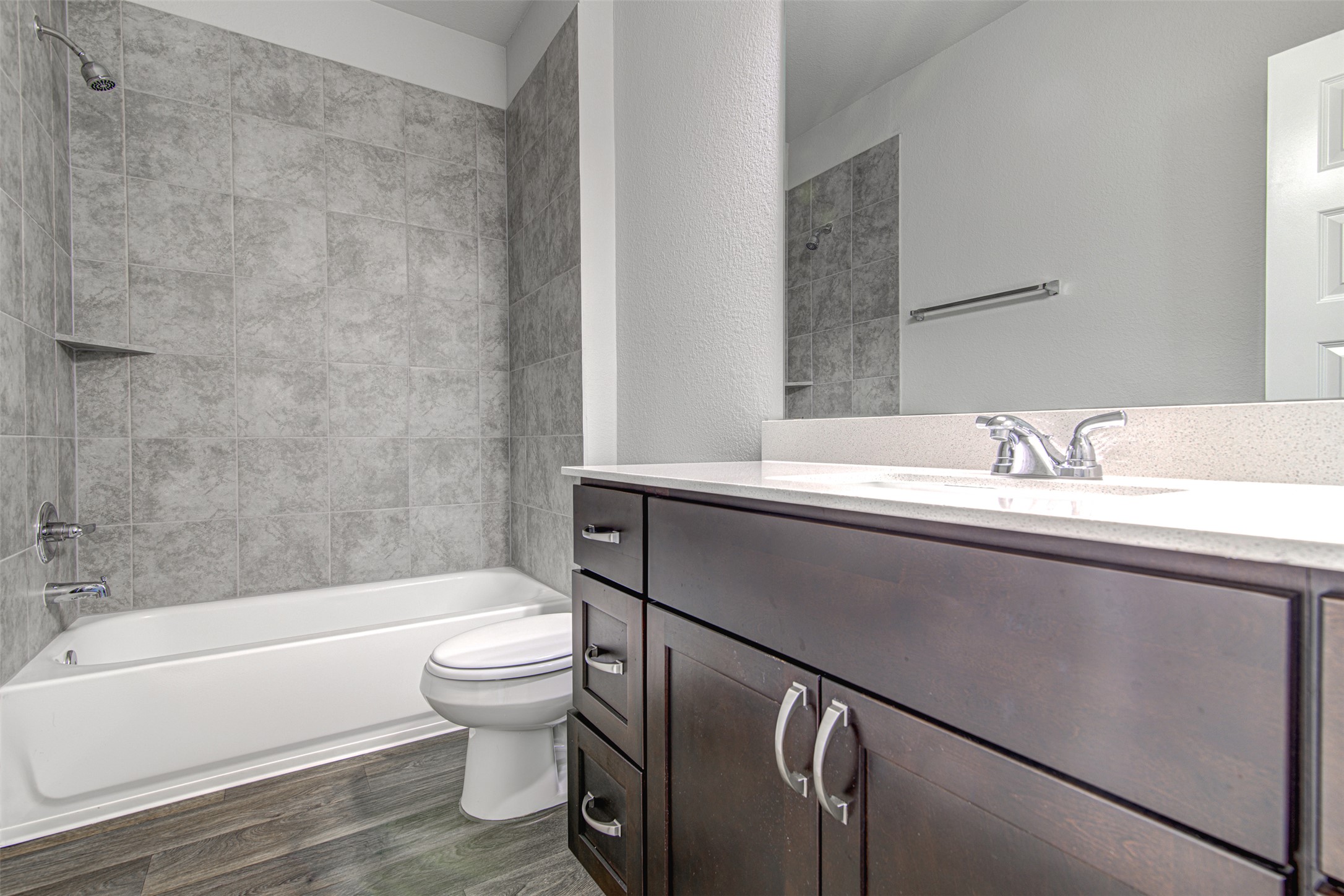 156 Tillage Road Elgin, TX 78621 - Photo 17 of 25 A well-appointed bathroom with contemporary fixtures and durable wood-look flooring.