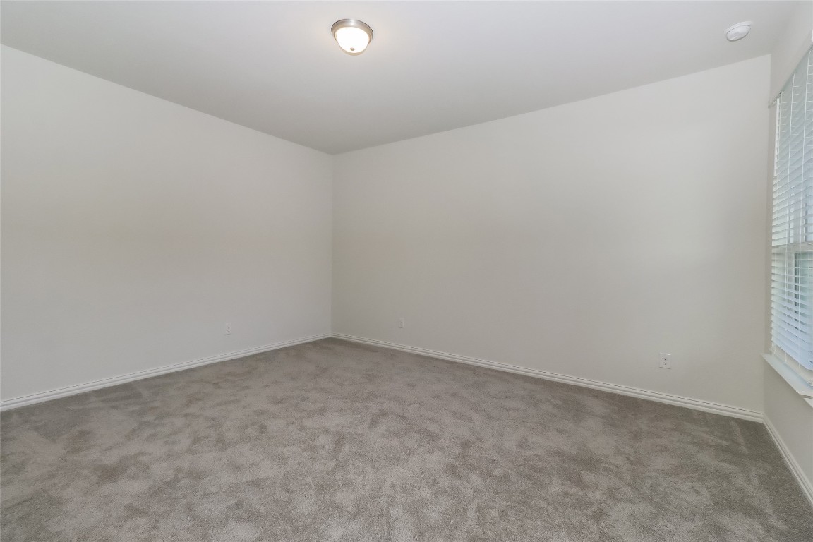 530 Ansley Court Taylor, TX 76574 - Photo 14 of 31 Carpeted spare room featuring baseboards