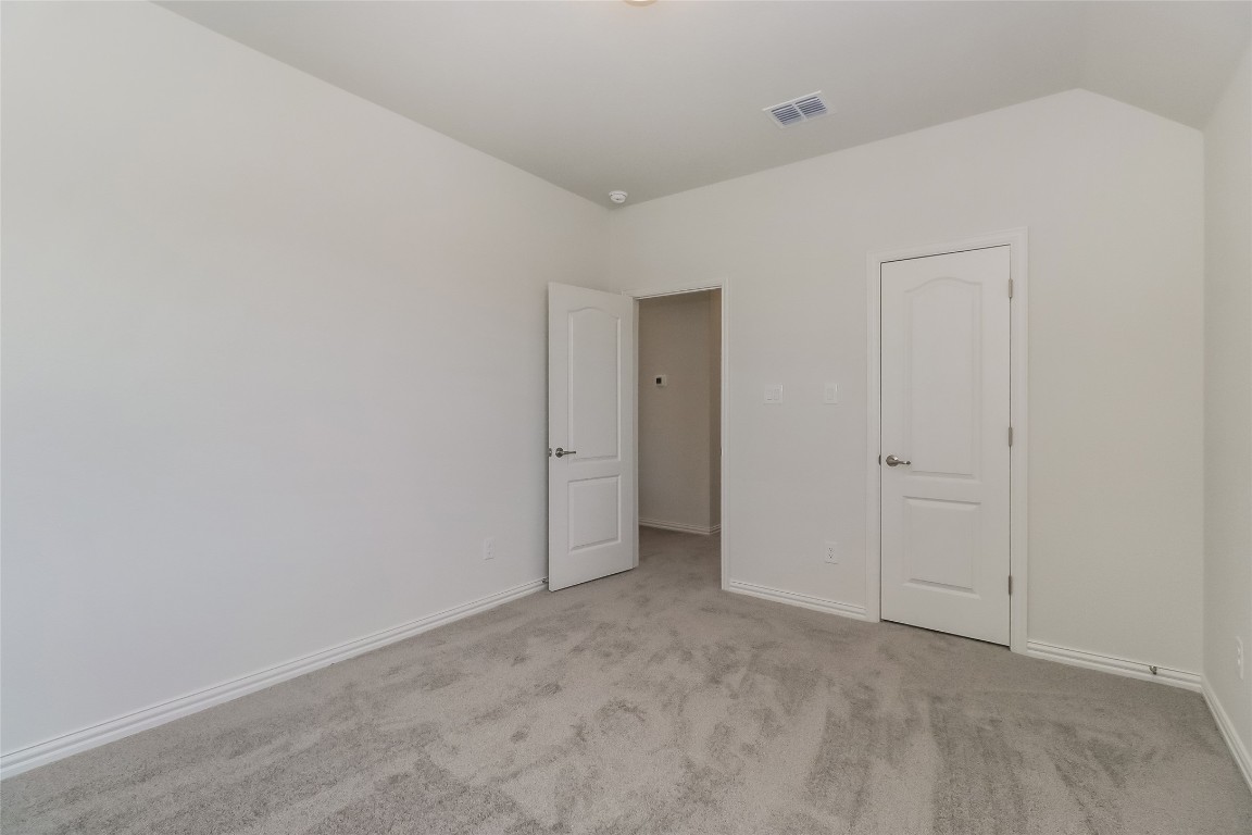 530 Ansley Court Taylor, TX 76574 - Photo 17 of 31 Unfurnished bedroom featuring light colored carpet and baseboards