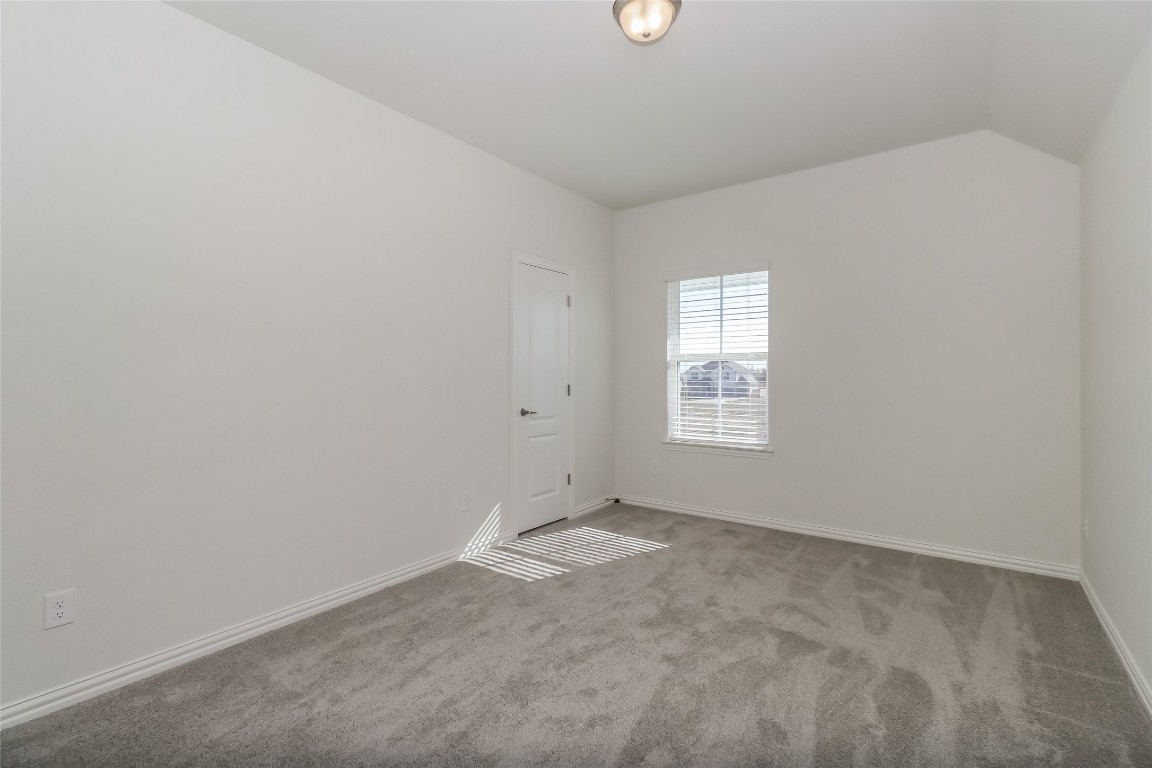 530 Ansley Court Taylor, TX 76574 - Photo 18 of 31 Unfurnished room featuring carpet floors and lofted ceiling