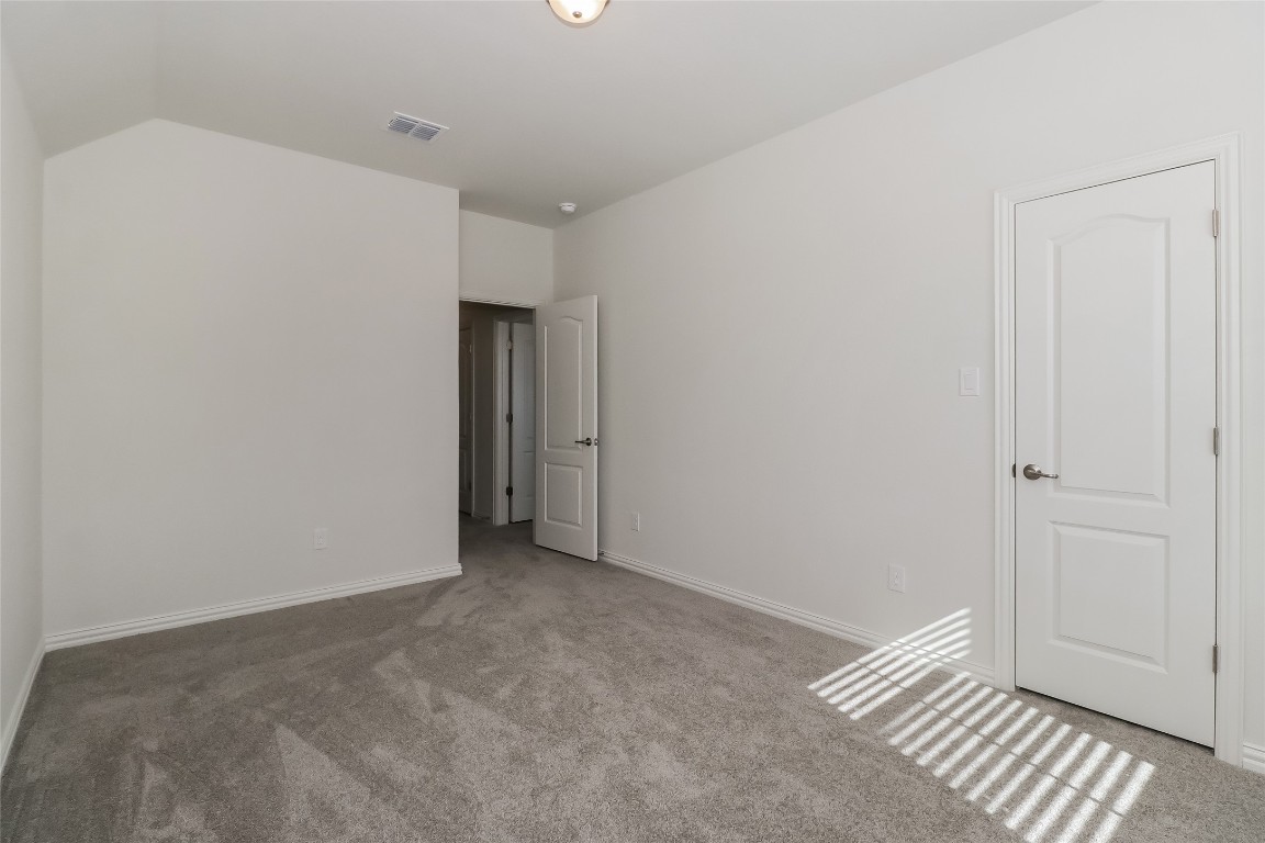 530 Ansley Court Taylor, TX 76574 - Photo 19 of 31 Unfurnished bedroom featuring carpet floors and lofted ceiling