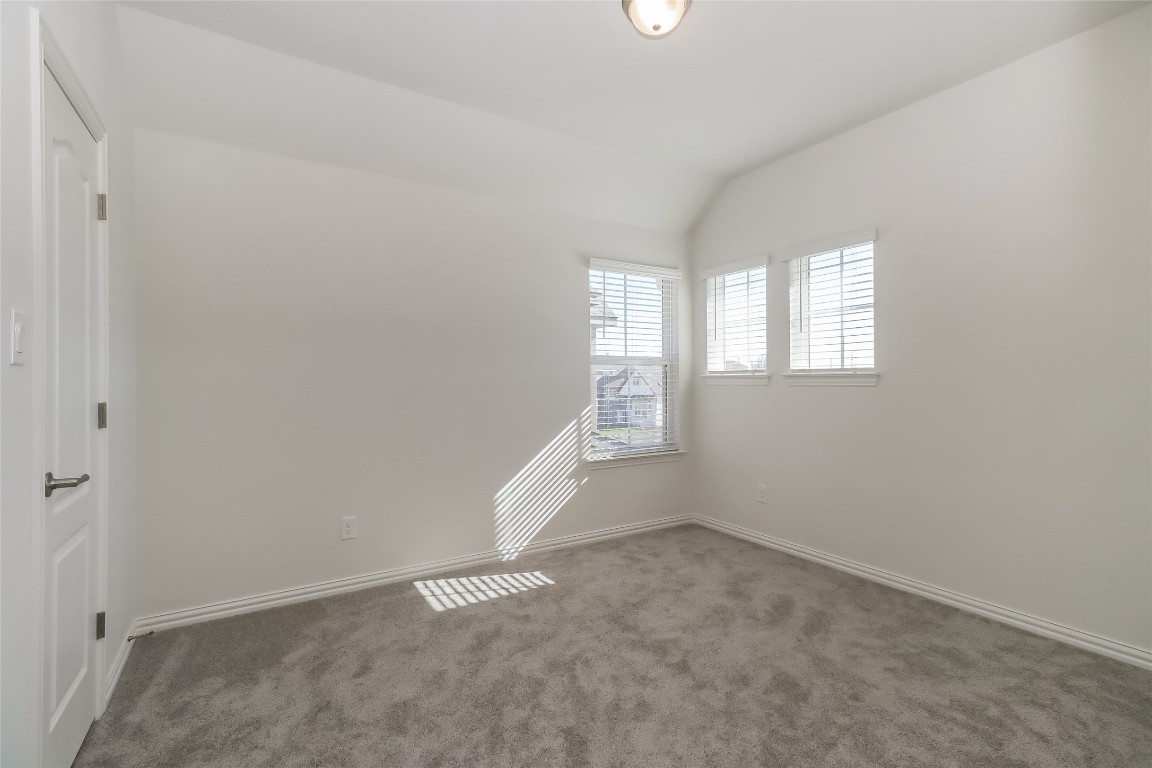 530 Ansley Court Taylor, TX 76574 - Photo 20 of 31 Unfurnished room featuring vaulted ceiling and carpet