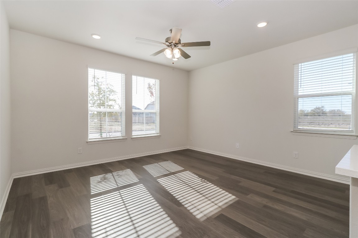 530 Ansley Court Taylor, TX 76574 - Photo 4 of 31 Unfurnished room with dark wood-style floors, recessed lighting, and a ceiling fan