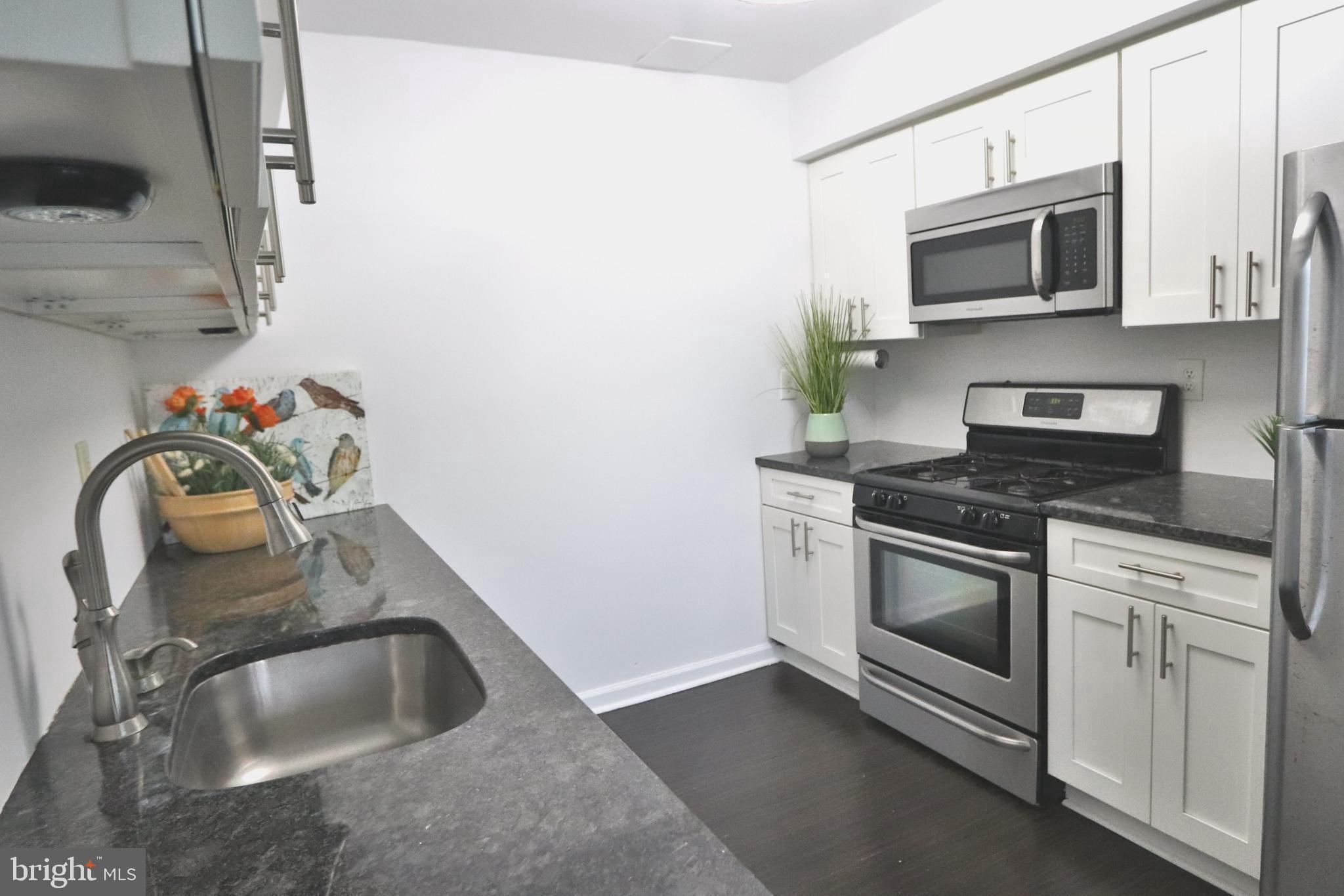 3125 Comly Road Philadelphia, PA 19154 - Photo 7 of 44 a kitchen with sink a microwave and stove