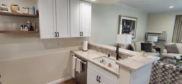 a view of a kitchen with a sink and dishwasher