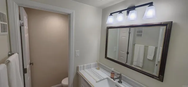 a bathroom with a sink a mirror and a toilet