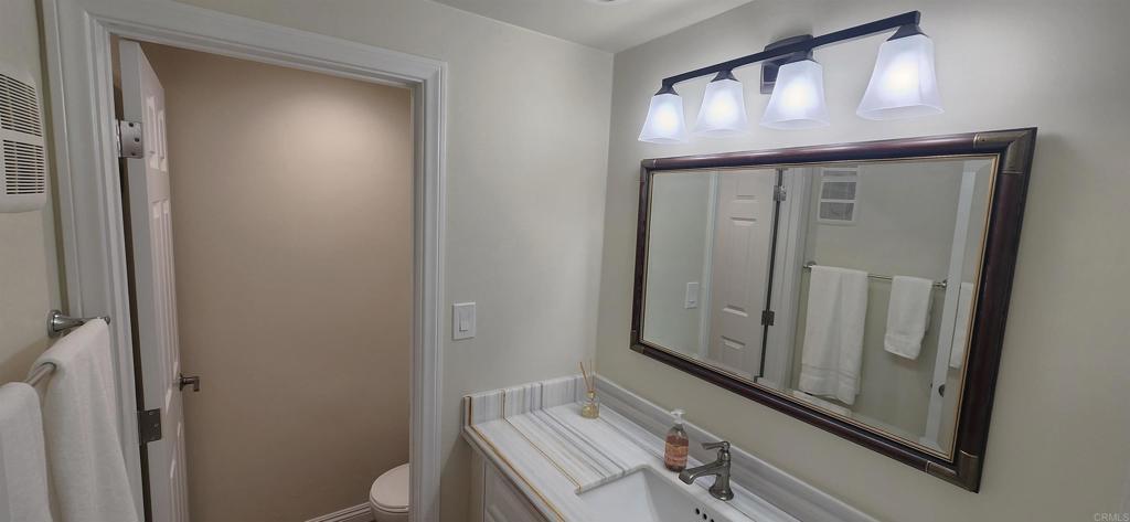 2005 Costa Del Mar Road, Unit 619 Carlsbad, CA 92009 - Photo 13 of 23 a bathroom with a sink a mirror and a toilet