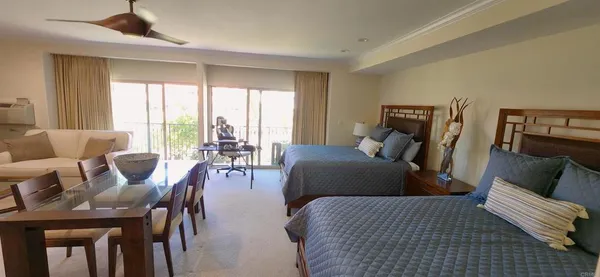 a bedroom with furniture and wooden floor