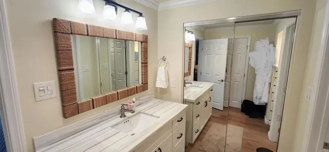 a en suite bathroom with a shower sink and mirror