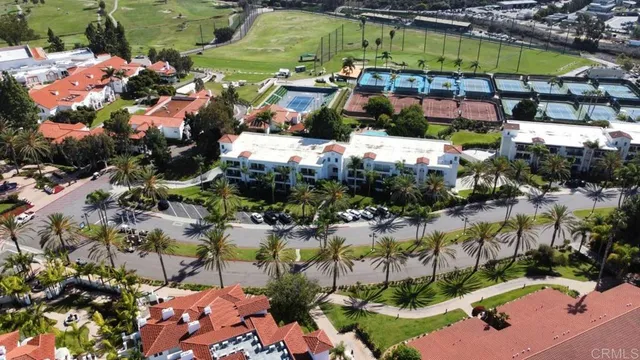 a view of a patio with lawn chairs under an umbrella