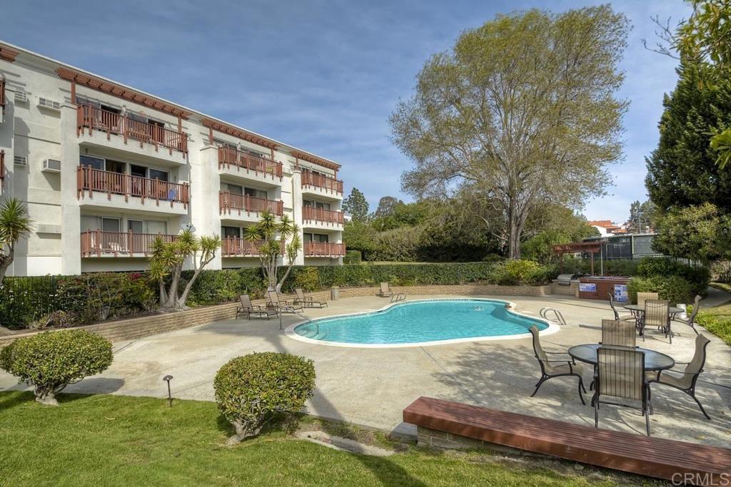 2005 Costa Del Mar Road, Unit 619 Carlsbad, CA 92009 - Photo 5 of 23 a swimming pool with outdoor seating and yard