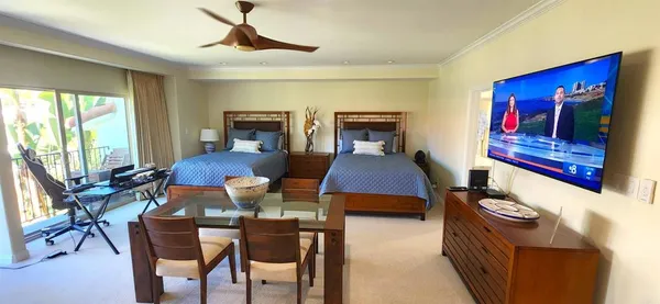 a living room with furniture a rug and a floor to ceiling window