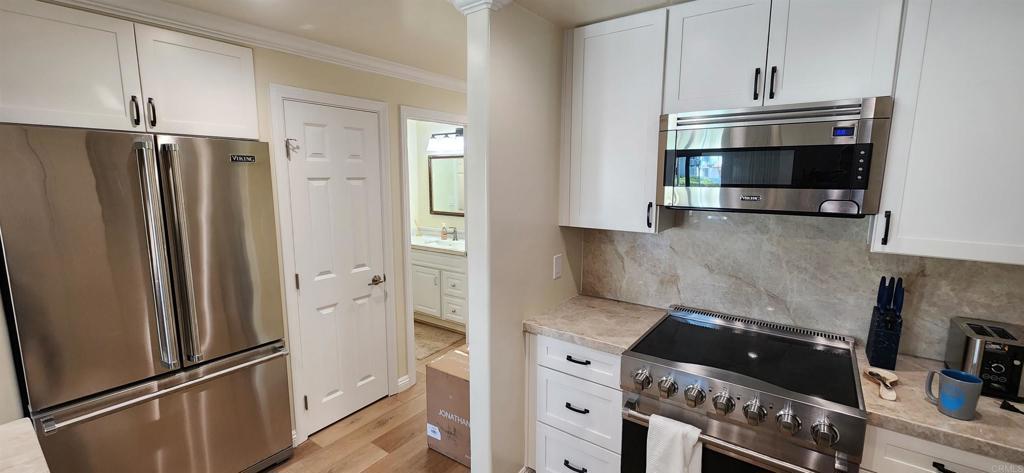 2005 Costa Del Mar Road, Unit 619 Carlsbad, CA 92009 - Photo 9 of 23 a kitchen with stainless steel appliances a refrigerator and a stove top oven