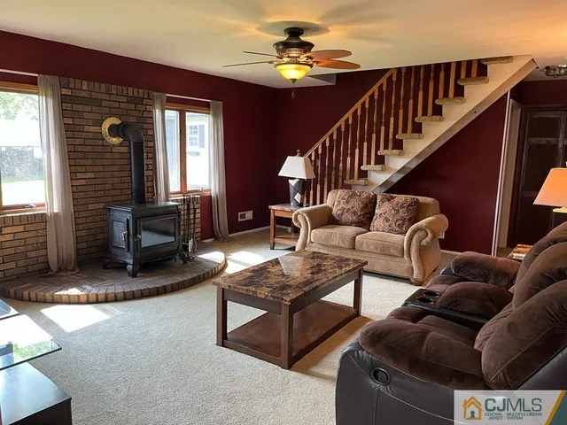 a living room with furniture ceiling fan and a window