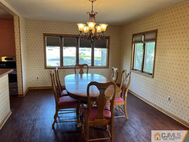 a view of a dining room with furniture and window