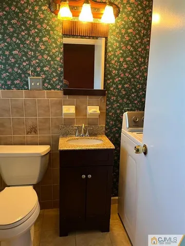 a bathroom with a toilet sink and mirror