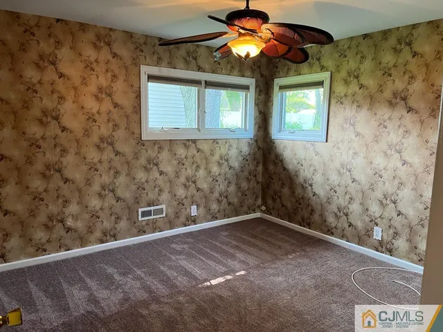 a view of a livingroom with a ceiling fan and window