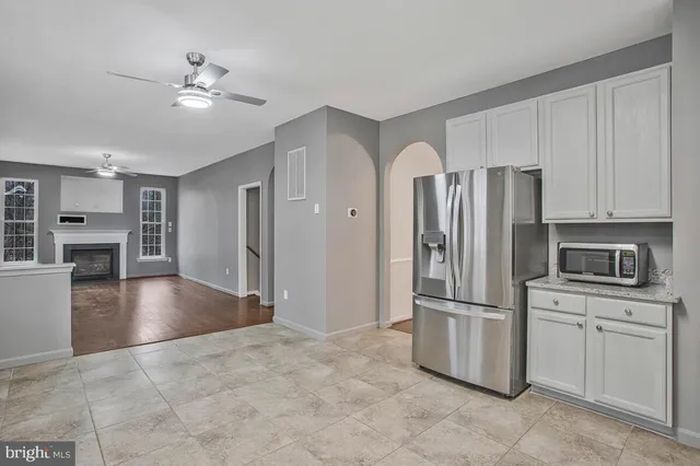 a kitchen with stainless steel appliances granite countertop a refrigerator sink and stove