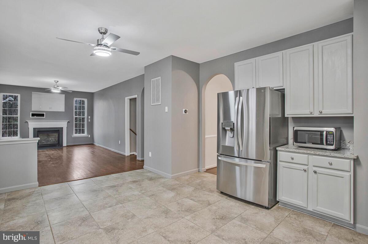2775 Scientists Cliffs Road Port Republic, MD 20676 - Photo 19 of 54 a kitchen with granite countertop a refrigerator and a stove top oven