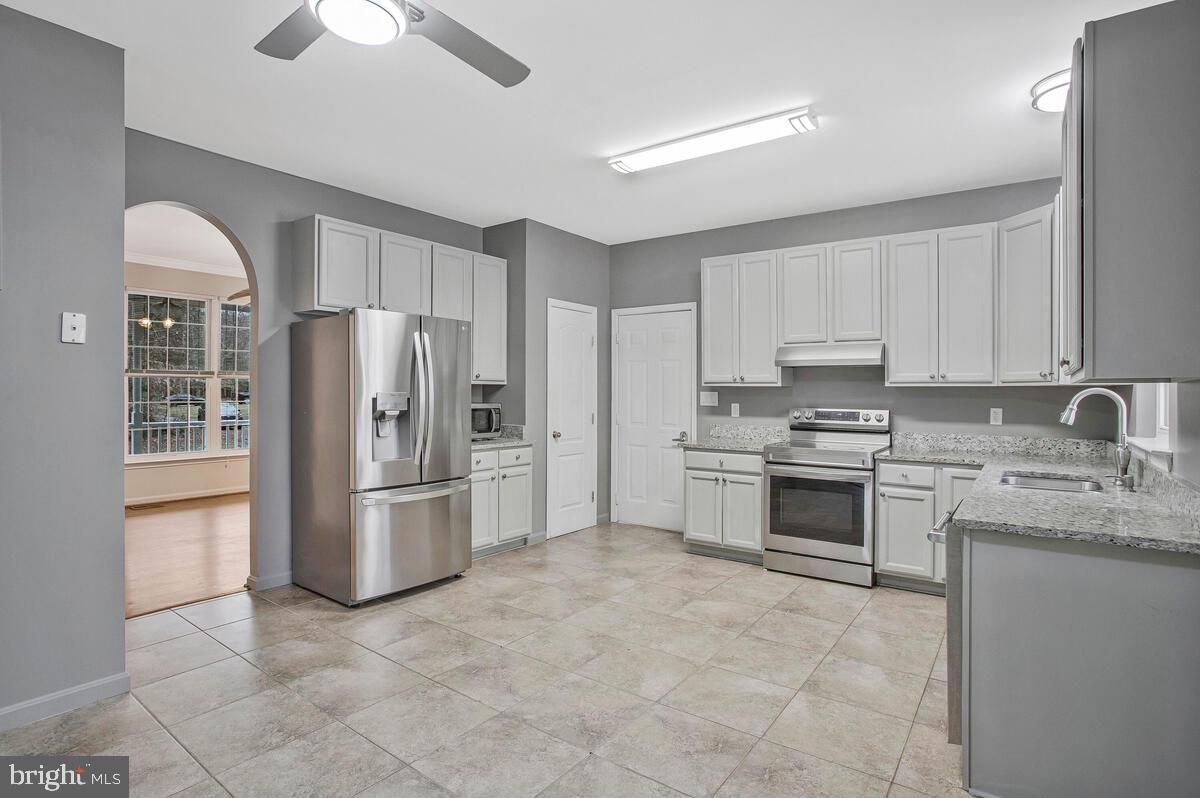 2775 Scientists Cliffs Road Port Republic, MD 20676 - Photo 20 of 54 a kitchen with stainless steel appliances granite countertop a refrigerator sink and stove
