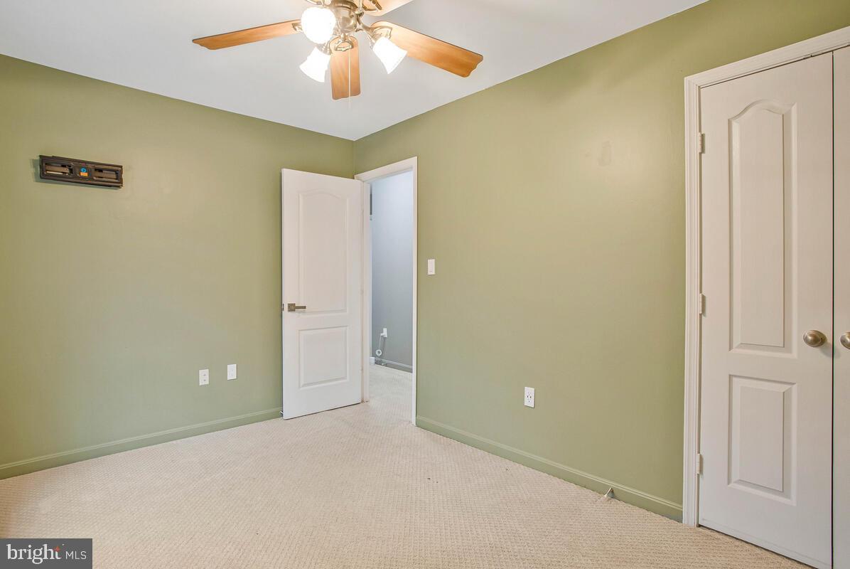 2775 Scientists Cliffs Road Port Republic, MD 20676 - Photo 24 of 54 an empty room with a chandelier fan and a chandelier fan
