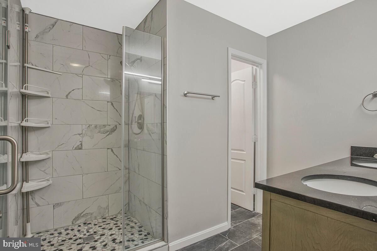 2775 Scientists Cliffs Road Port Republic, MD 20676 - Photo 27 of 54 a bathroom with a granite countertop shower and a sink