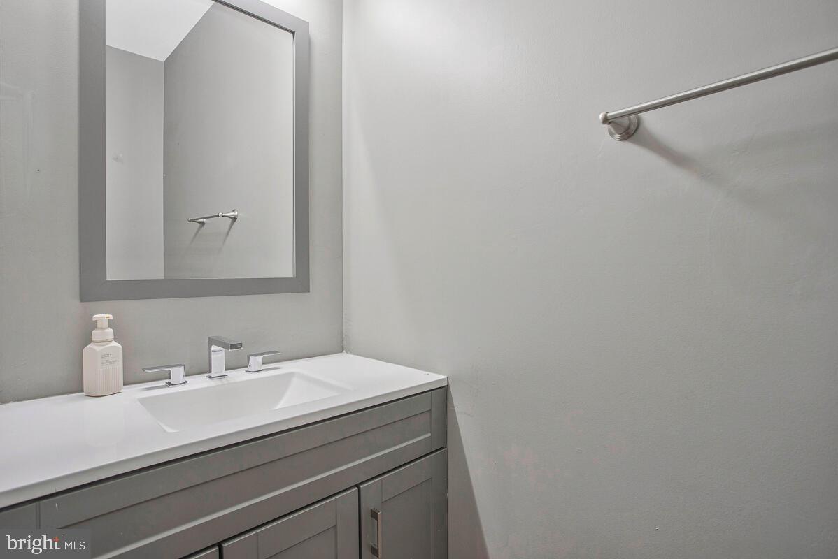 2775 Scientists Cliffs Road Port Republic, MD 20676 - Photo 29 of 54 a bathroom with a sink and a mirror