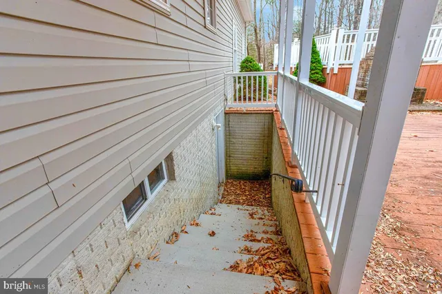 a view of a house with a wooden deck