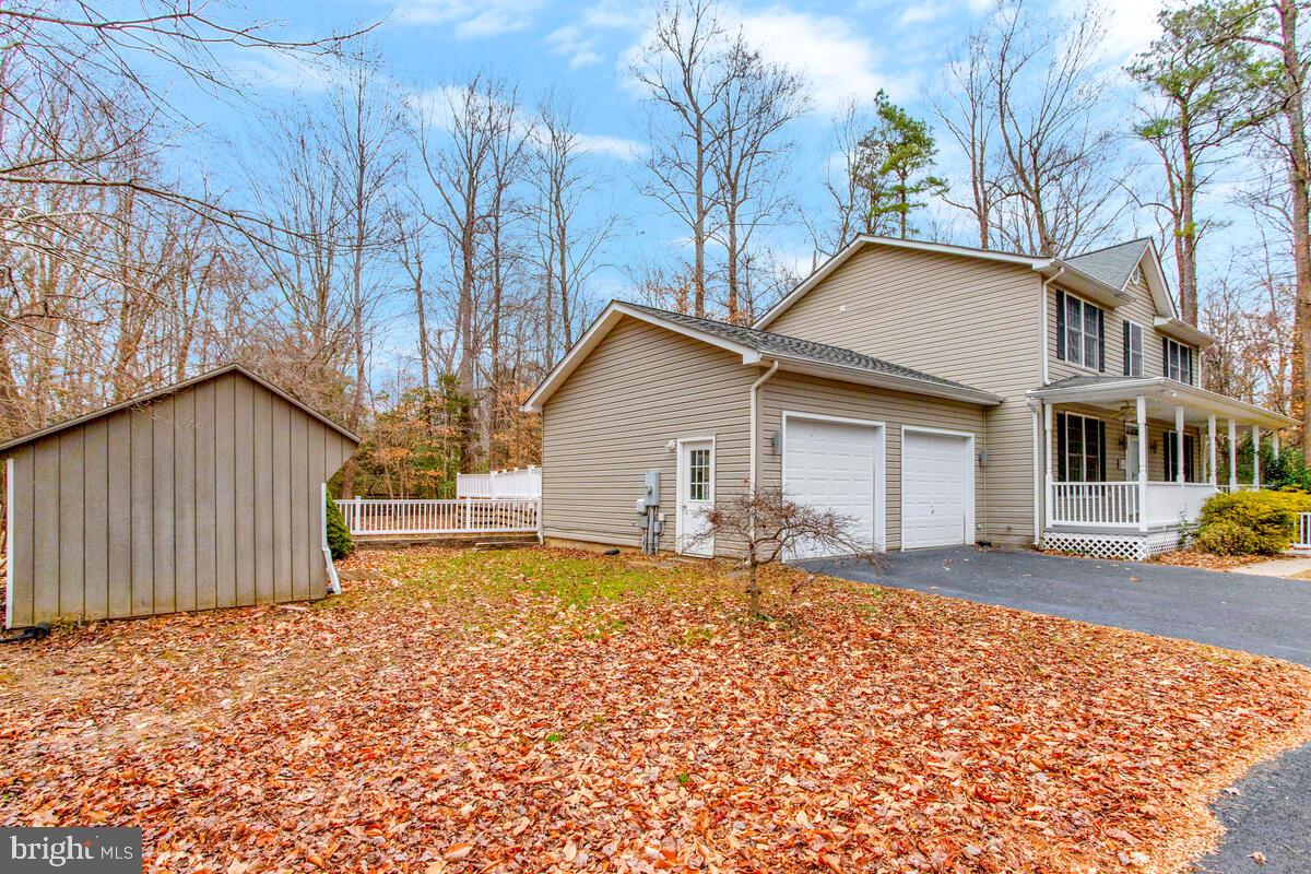 2775 Scientists Cliffs Road Port Republic, MD 20676 - Photo 7 of 54 a front view of a house with garden