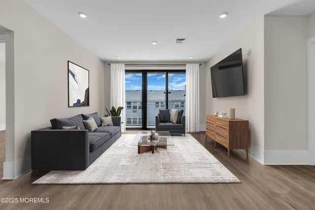 a view of an empty room with a fireplace and a window